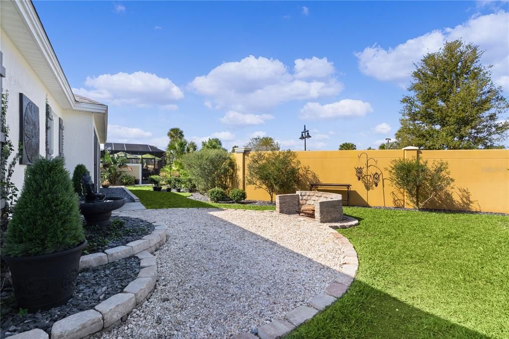 OVERSIZED YARD OFFERS A GRAVEL PATIO WITH CUSTOM FIREPIT!