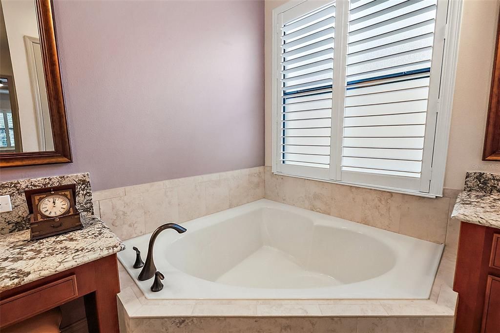 Plantation shutters ensure privacy while owner's enjoy a soak.