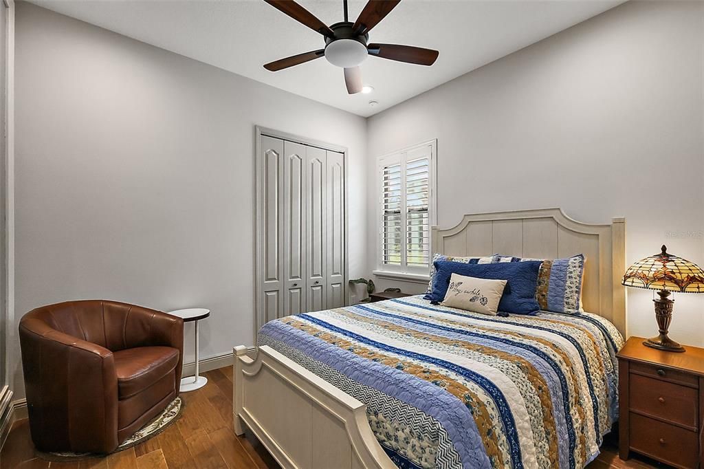 The third bedroom (11 x 11) features hardwood flooring, plantation shutters, and a ceiling fan.