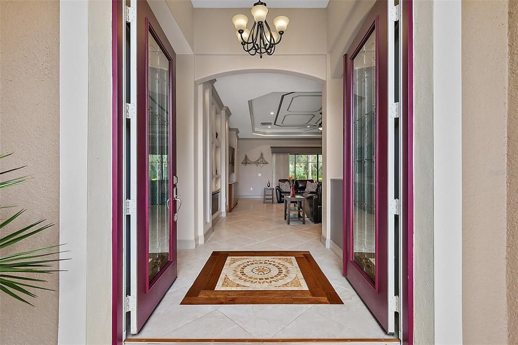 Double Front entrance doors with a custom tile inlay welcome you home.