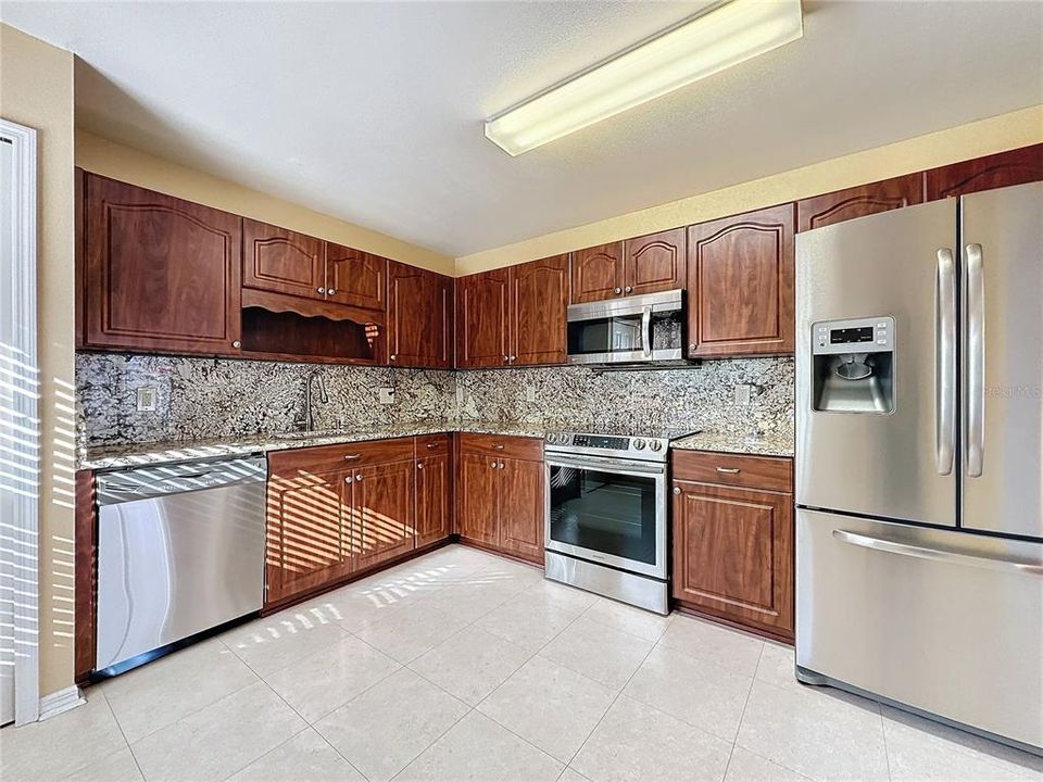 Kitchen has granite countertops/ backsplash & cabinets refaced