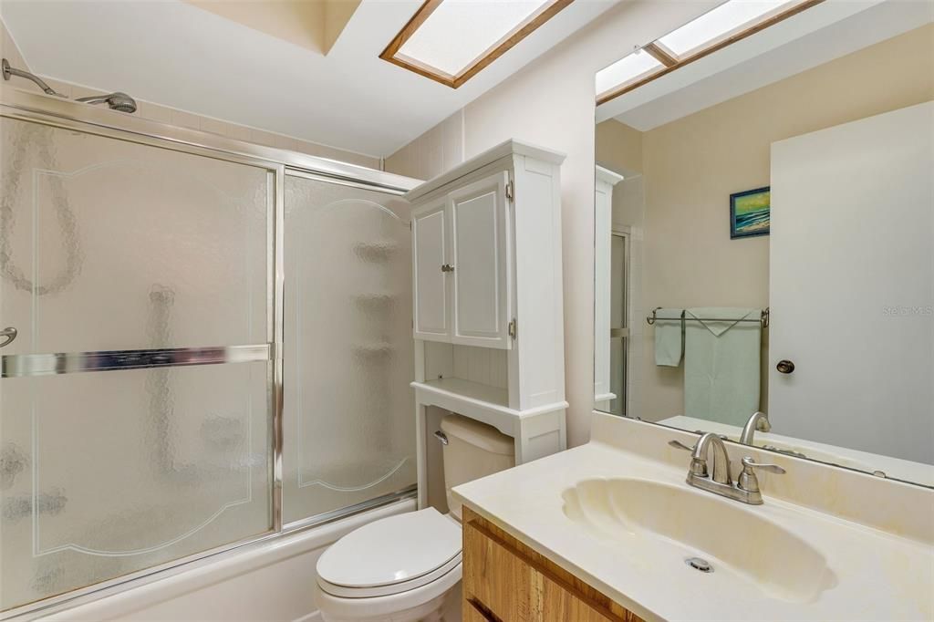 Hall bath conveniently located between guest suite & main living~