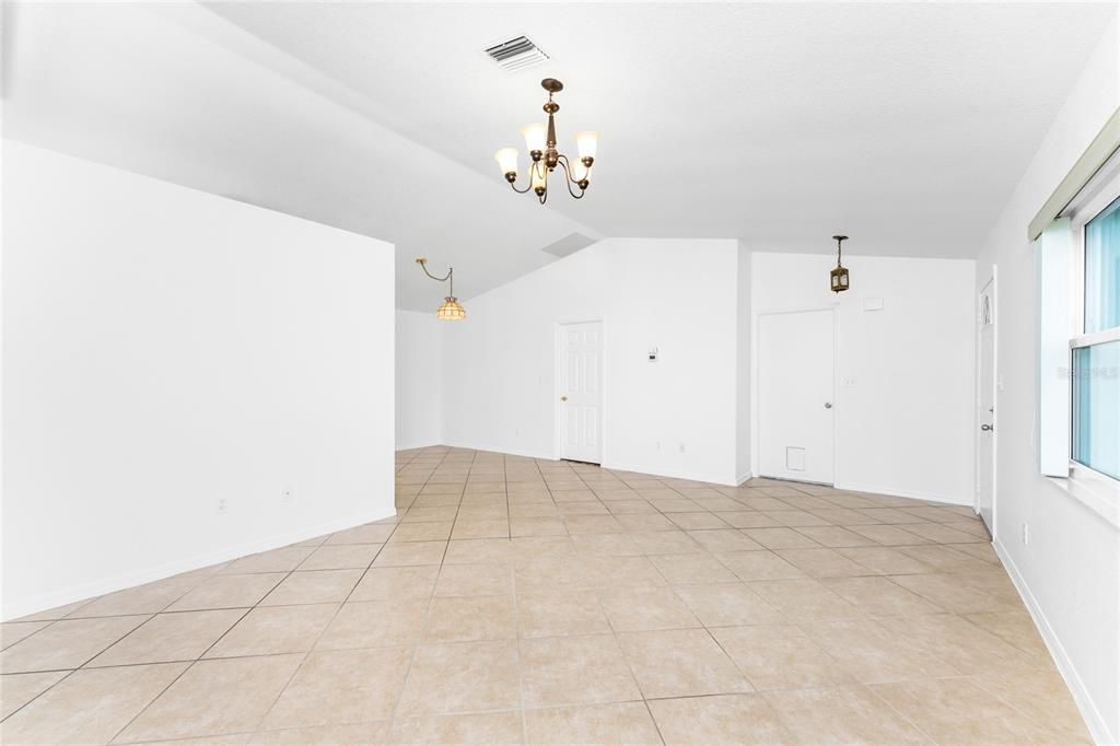 Living Room Looking to Garage Door and Primary Bedroom Door