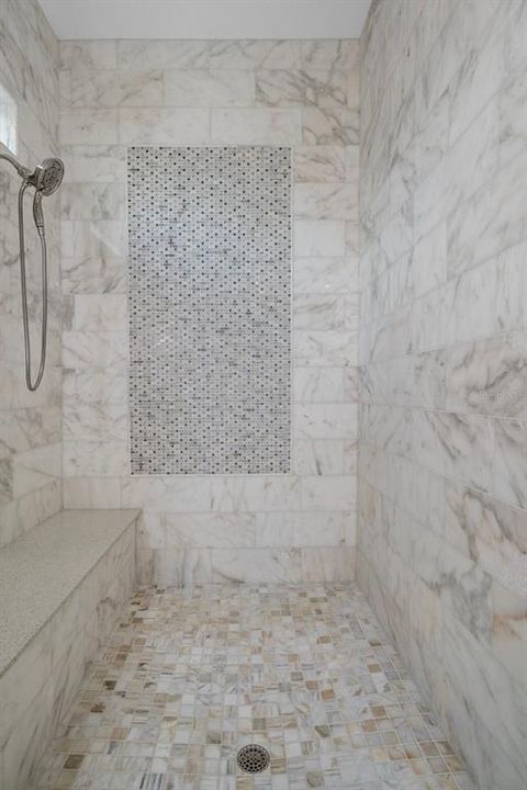 Oversized shower with double shower heads and bench