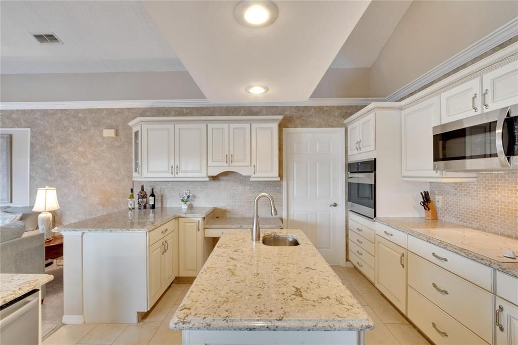 Large kitchen island with prep sink.