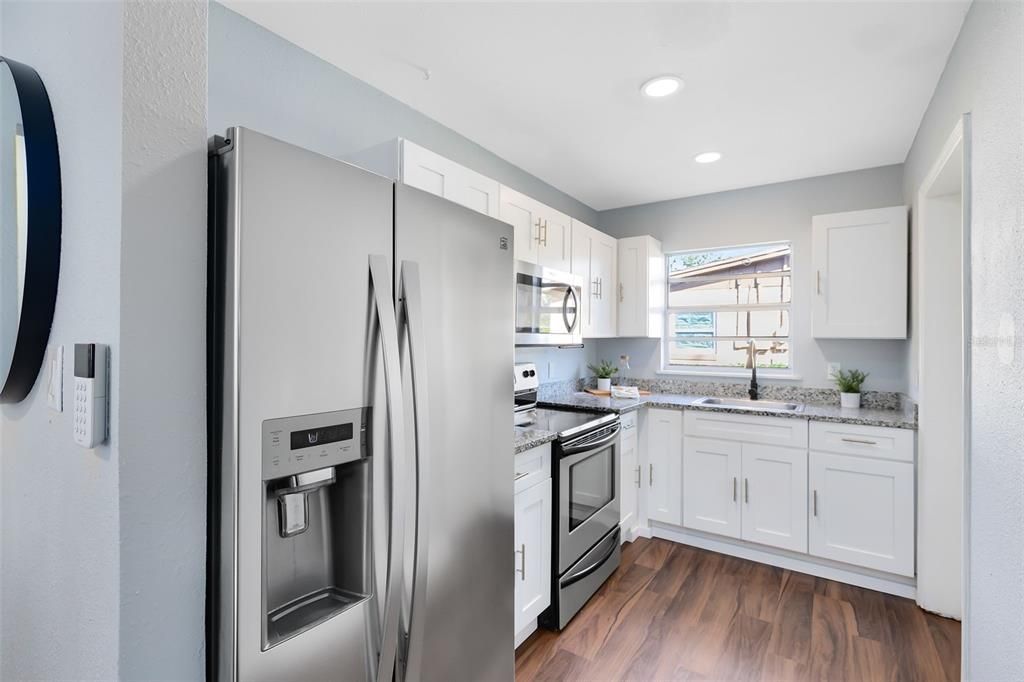 Galley-style kitchen, featuring sleek stainless steel appliances