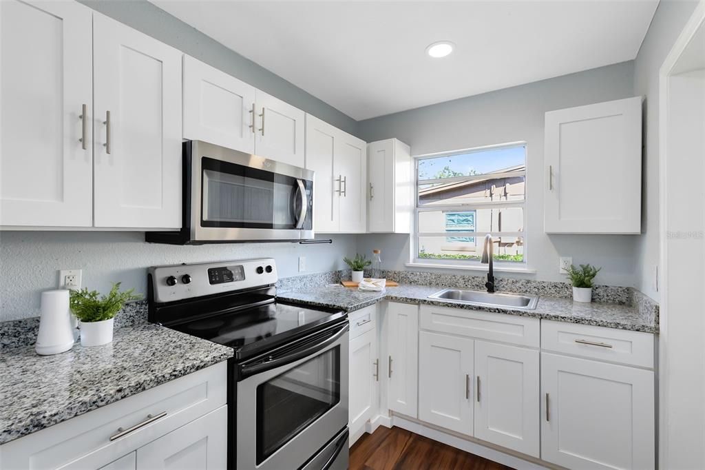 Stunning granite countertops, and ample cabinet space to inspire your culinary creativity.