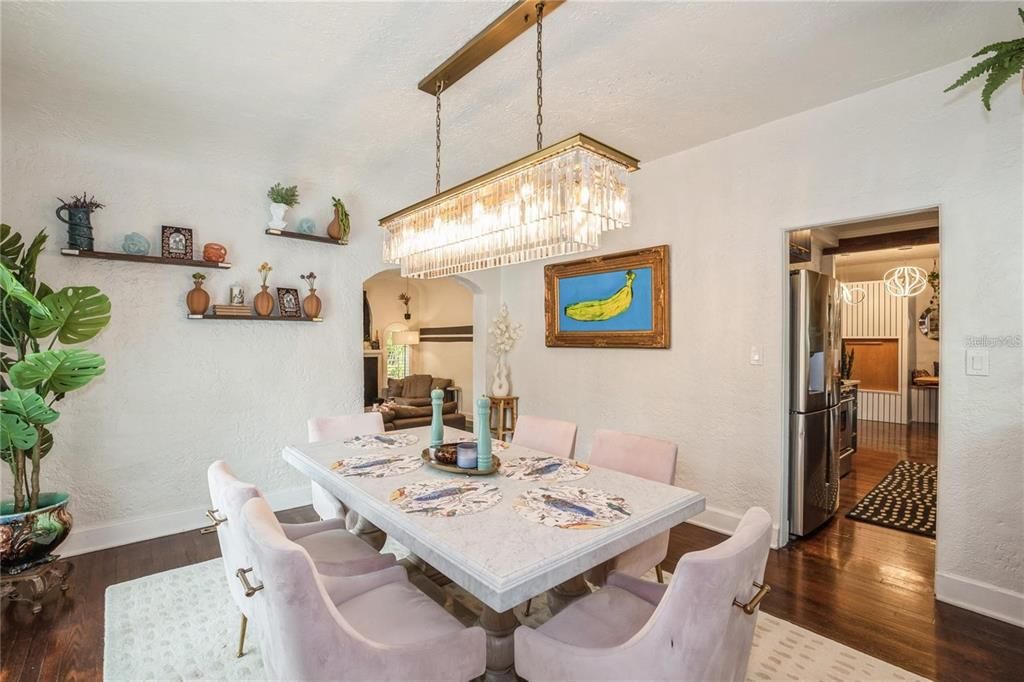 Upon Entering, the Main House boasts with Beautiful Original Wood Floors, Vaulted Ceilings & a Wood Burning Fireplace. To the right is a Spacious Living Room perfect for entertaining that seamlessly flows into the Dining Room.