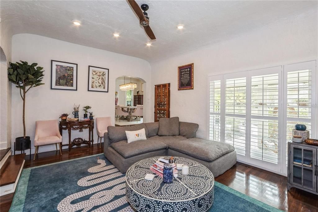 Upon Entering, the Main House boasts with Beautiful Original Wood Floors, Vaulted Ceilings & a Wood Burning Fireplace. To the right is a Spacious Living Room perfect for entertaining that seamlessly flows into the Dining Room.