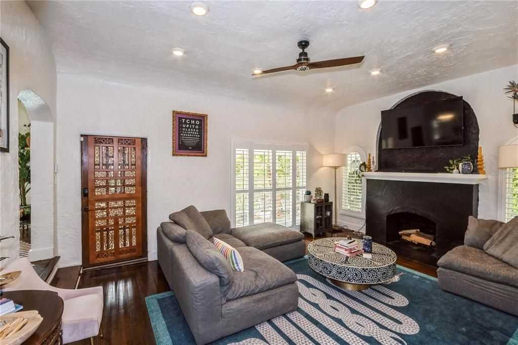 Upon Entering, the Main House boasts with Beautiful Original Wood Floors, Vaulted Ceilings & a Wood Burning Fireplace. To the right is a Spacious Living Room perfect for entertaining that seamlessly flows into the Dining Room.