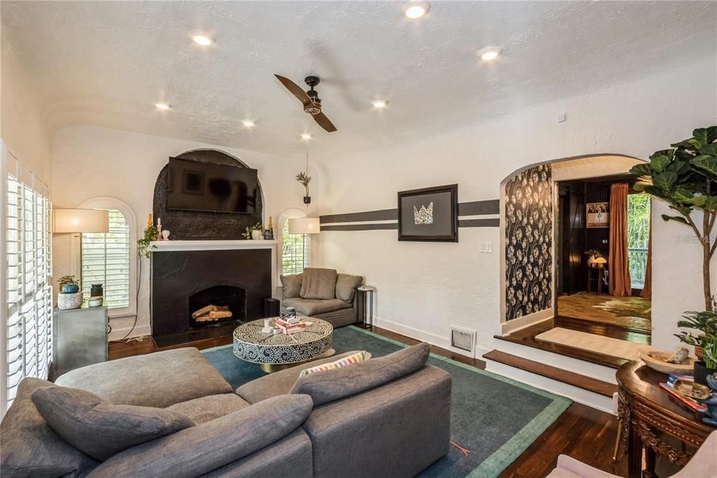 Upon Entering, the Main House boasts with Beautiful Original Wood Floors, Vaulted Ceilings & a Wood Burning Fireplace. To the right is a Spacious Living Room perfect for entertaining that seamlessly flows into the Dining Room.