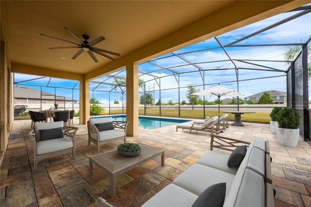 The open living, dining and kitchen are the perfect blend of comfort and style with two sets of sliding glass doors that open up to a large PAVER LANAI and SCREENED POOL for those who seek indoor/outdoor living and entertaining. Virtually Staged.