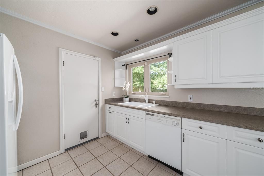 Kitchen window overlooks backyard