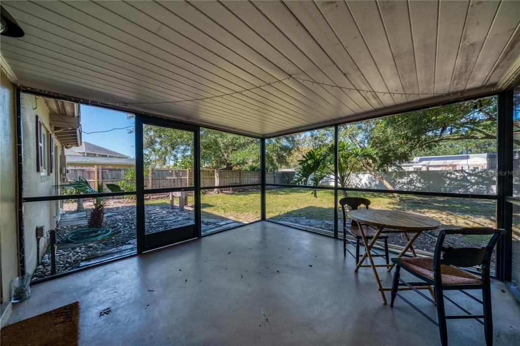 Screened room overlooks spacious backyard