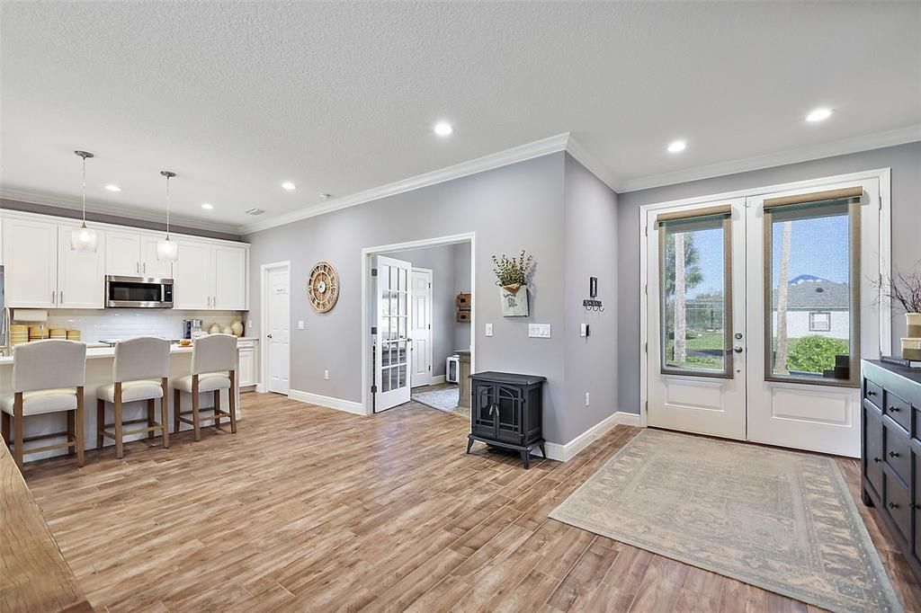 Double door entry, wood-like tile, crown molding and recessed lighting. Gorgeous!