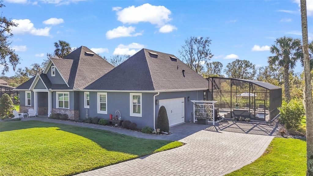 Side garage entry with pavered driveway and walkway