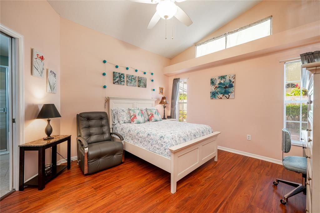 The ideal SPLIT BEDROOM FLOOR plan gives you an airy retreat in the back of the home in your PRIMARY SUITE, another soaring ceiling, transom windows and separate access to the lanai let the light pour in and the homeowner will enjoy a WALK-IN CLOSET and private en-suite bath.