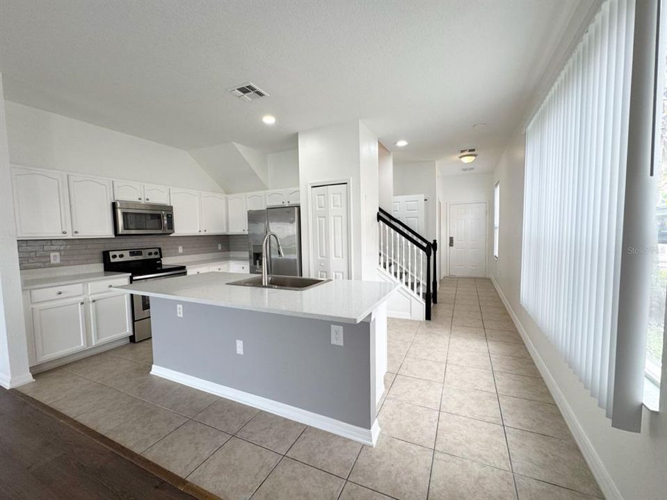 Kitchen with new countertops, backsplash and stainless appliances