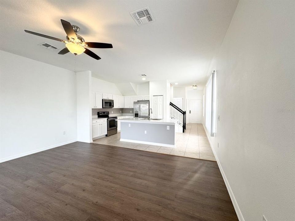 Living Room with New Luxury Vinyl Flooring, fan and blinds