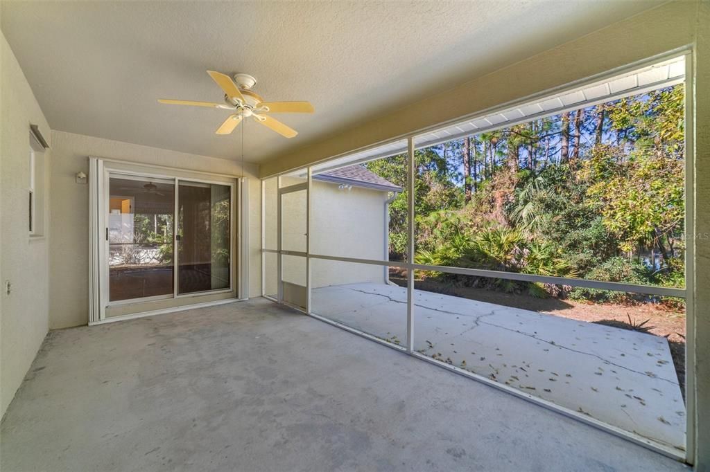 LARGE SCREENED LANAI OFFERS WOODED VIEWS.