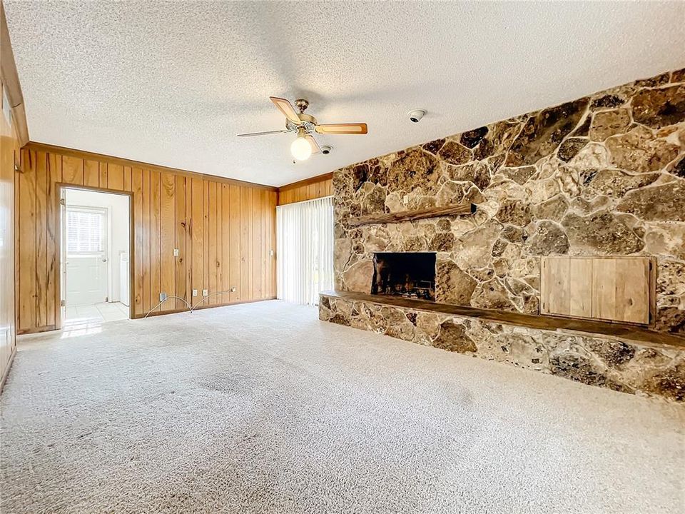 Family room with massive wood burning fireplace w/wood box storage.