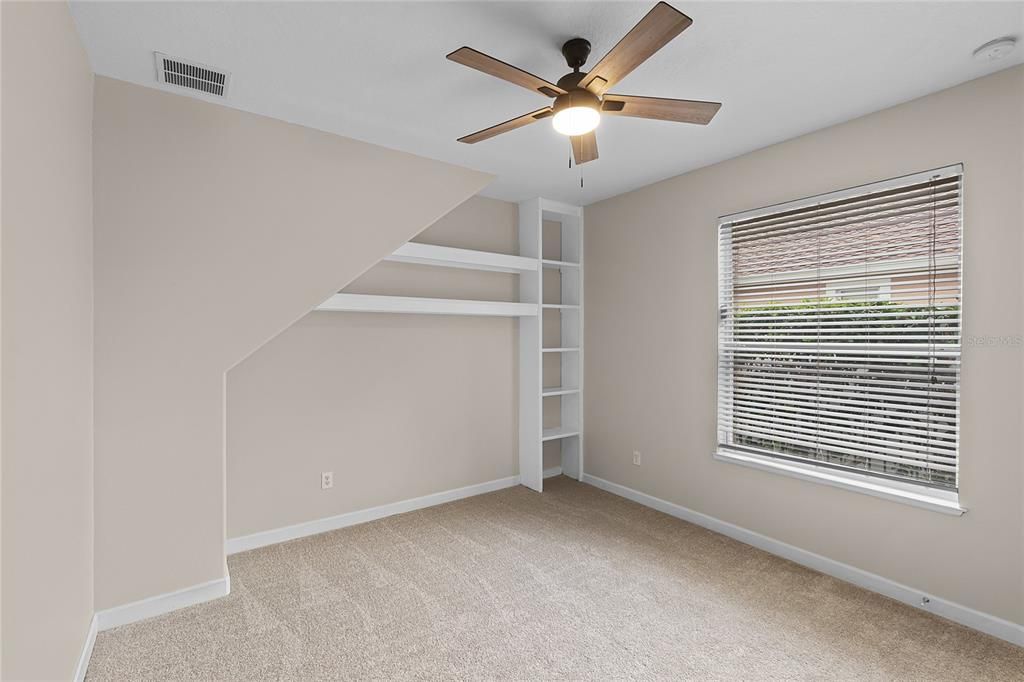 4TH BEDROOM WITH BUILT IN SHELVES, NEXT TO THE POOL.