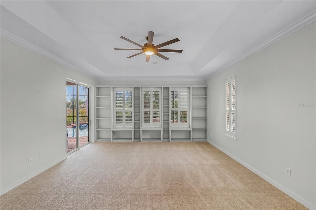 MASTER BEDROOM - HUGE MASTER CLOSET, SHUTTERS THROUGHOUT, WALL LIBRARY & CONSERVATION VIEW. NEW CARPET.