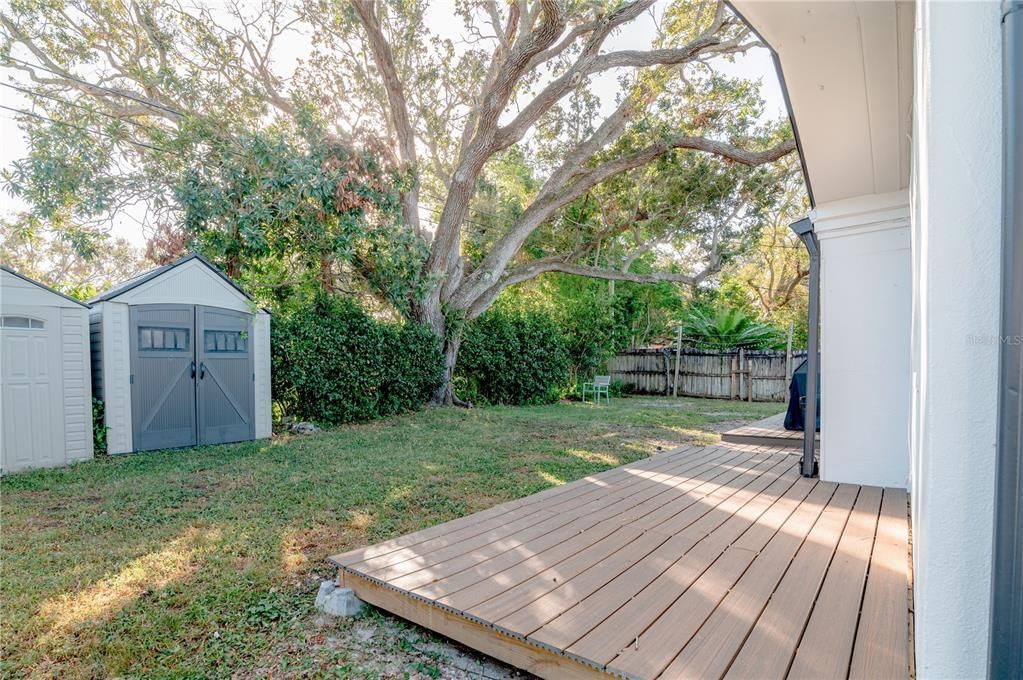 The back yard has a new composite deck that is along the entire rear of the home, yard space, and 2 storage sheds.