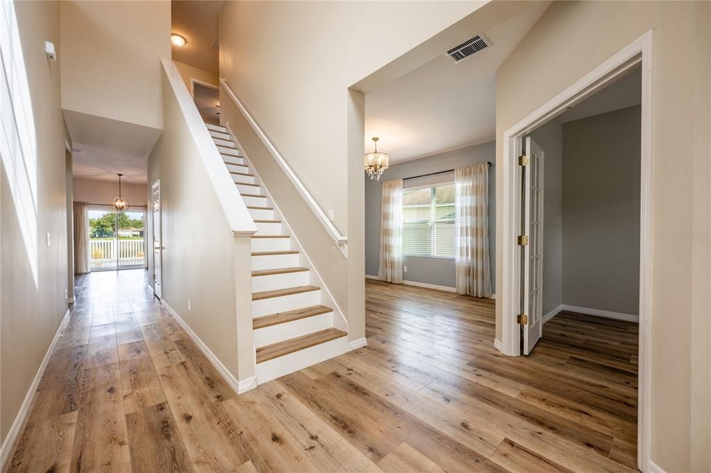 The light and bright flowing floor plan starts in the TWO-STORY FOYER - take note of the LUXURY VINYL PLANK wood floors you will find throughout the main floor lending a luxurious feel to this beautiful home!