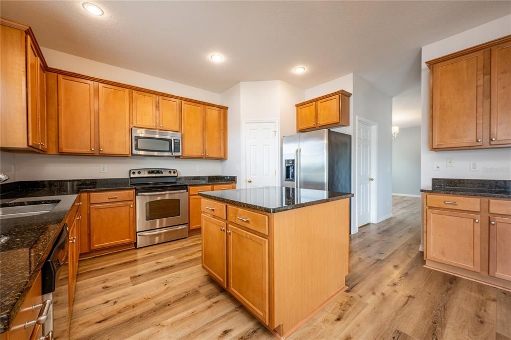 The kitchen was designed with the home chef in mind delivering 42” solid wood cabinetry, GRANITE COUNTERTOPS, a large PREP ISLAND, walk-in pantry for ample storage and STAINLESS STEEL APPLIANCES.