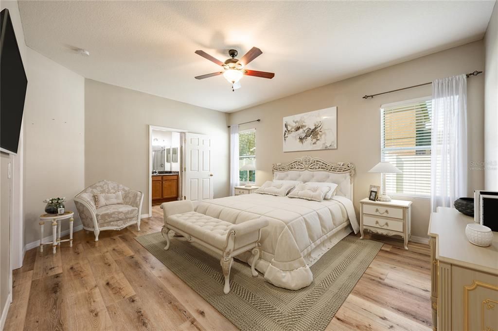 Before heading upstairs take time to explore your MAIN FLOOR PRIMARY SUITE, another generous space with plenty of light, plus a WALK-IN CLOSET and private en-suite bath with an extended dual sink vanity and walk-in shower behind glass doors. Virtually Staged.