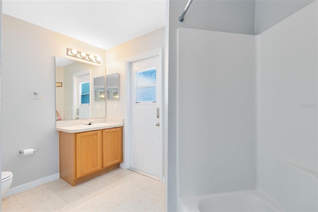 Guest bathroom with access to the pool and patio