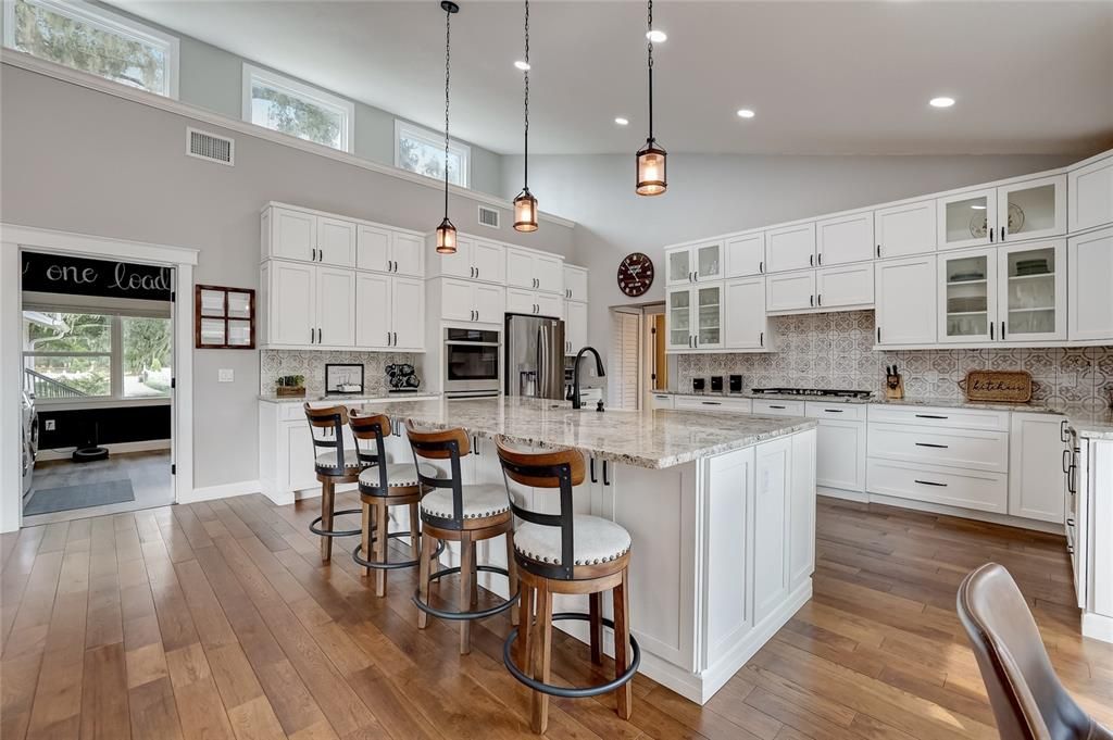 kitchen with transcom windows and entrance to expansive laundry room