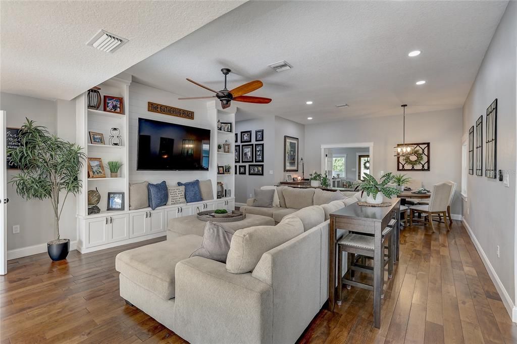 Family room in main house with front entry in the distance divided with french doors