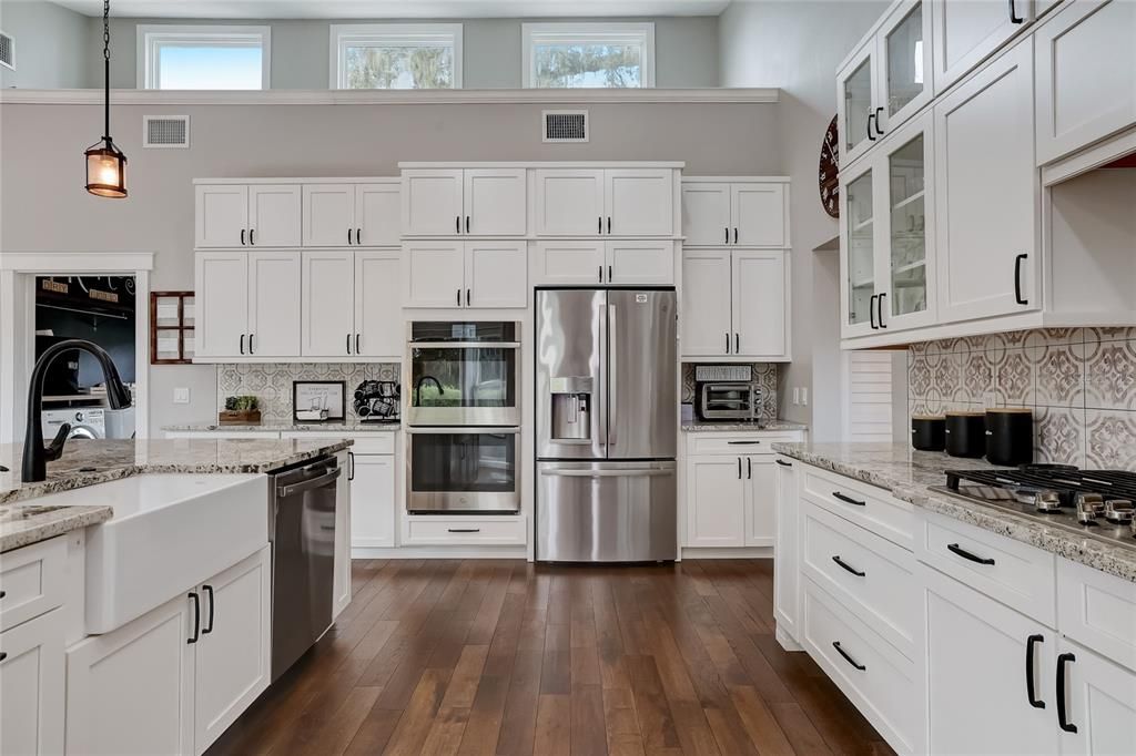 This kitchen is a chefs delight with gas top cooking, farm house sink and double ovens