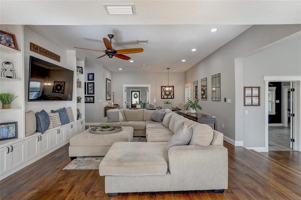 Family room with custom built ins with shelving and loads of storage