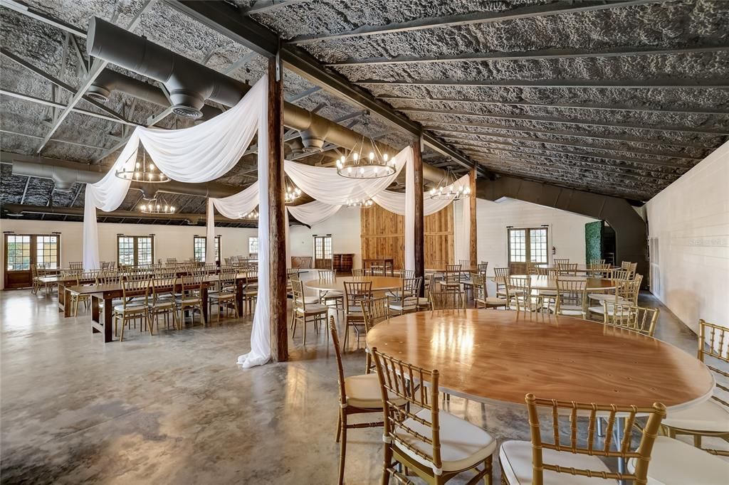 Wedding venue that holds up to 150 with barn doors that open wide and pass through bar