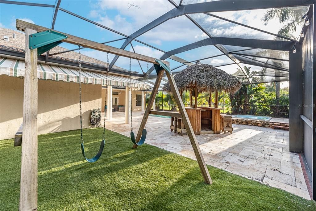 Tucked out of view inside the screened lanai you'll discover a sturdy, custom-designed play area.