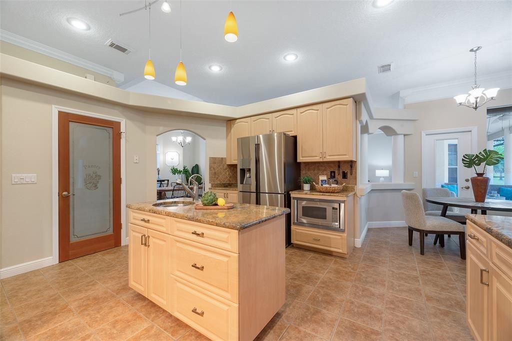 A spacious walk-in pantry behind the frosted door conceals all your storage.