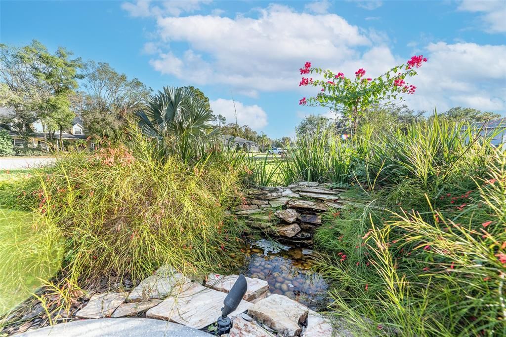 Pause midway to the front door to admire the tranquil view of a cascading water garden.