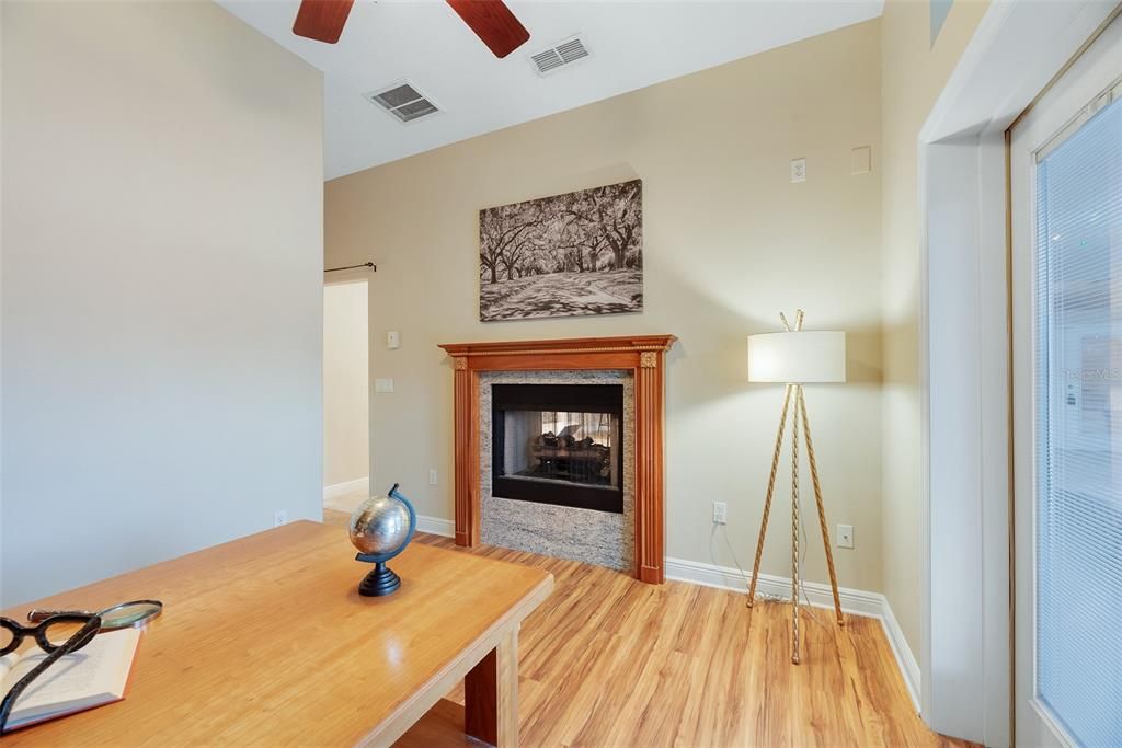 The opposite side of the family room fireplace opens in the private office/study at the rear of the home.