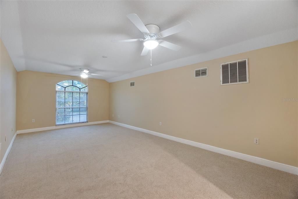 Upstairs, is a massive (36x14) 5th bedroom or bonus room with newly upgraded carpeting, a full bathroom, and a walk-in closet—ideal for guests or as extra living space.