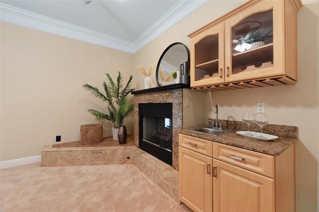 Double sided propane gas fireplace and wet bar complete the family room.