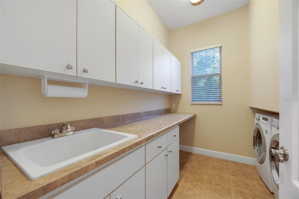 Next to the garage and kitchen on the first floor is a large laundry room with utility sink, and plenty of storage and folding space because the washer & dryer (electric) are tucked into the wall.