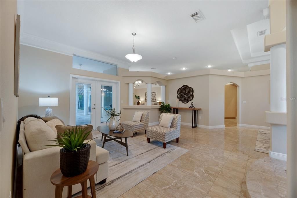 Natural light floods in through the french doors and transom window above.