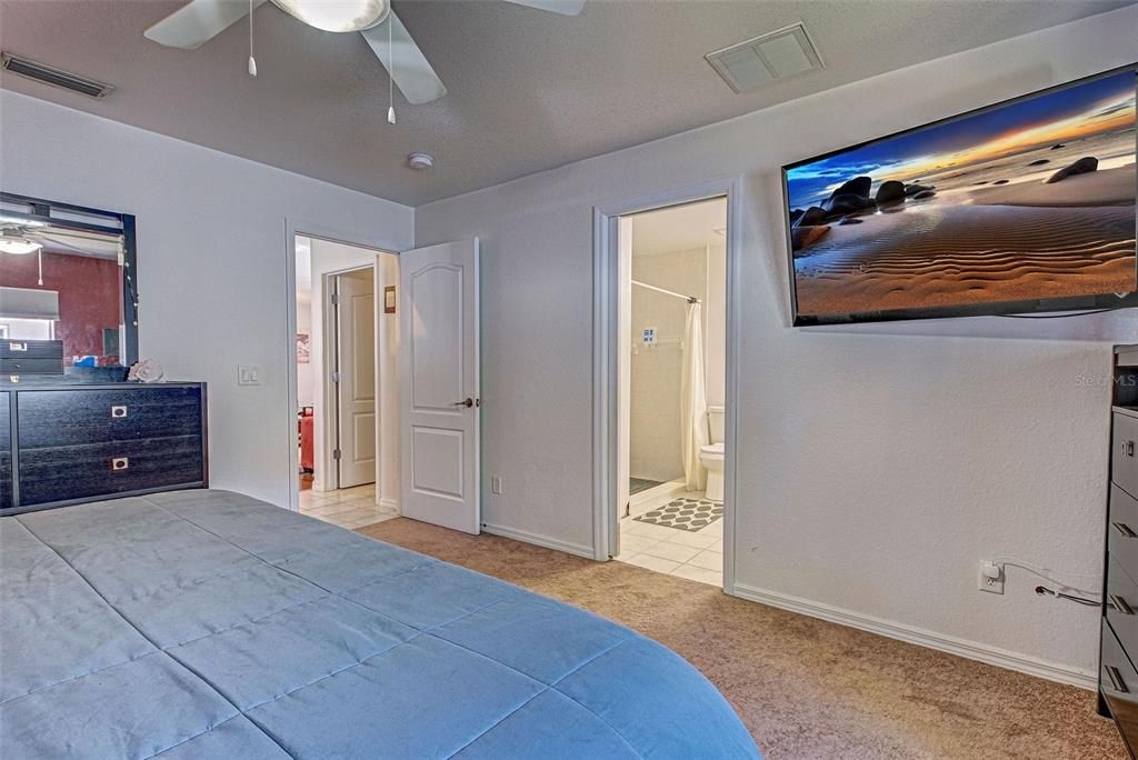 The primary bedroom has a ceiling fan and an ensuite bathroom.