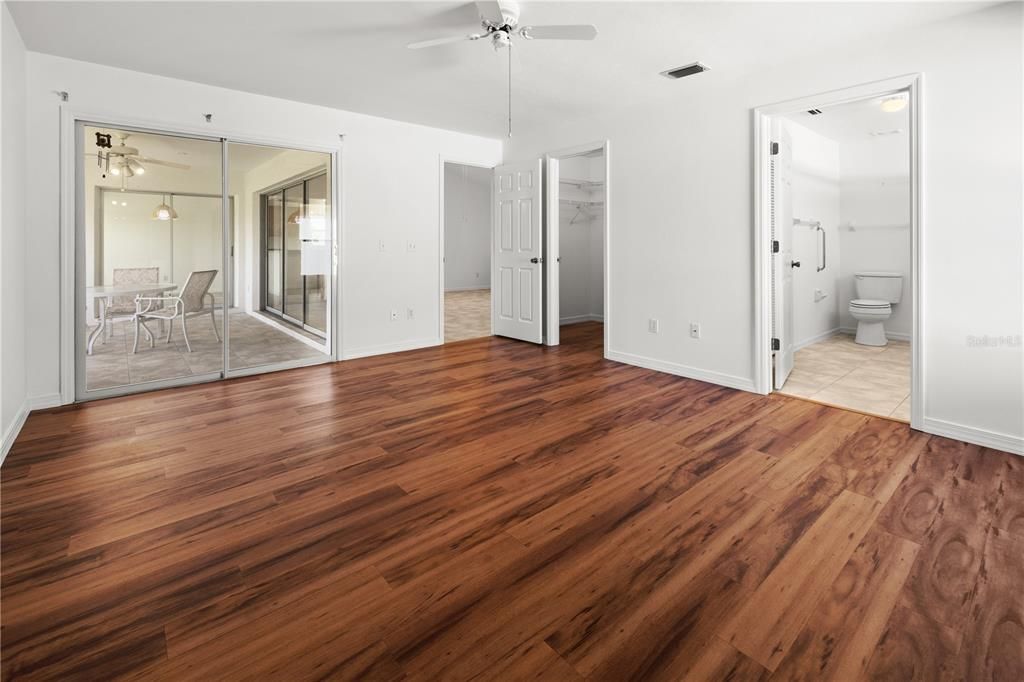 VIEW OF THE PRIMARY BEDROOM TOWARDS THE LANAI AND BATHROOM