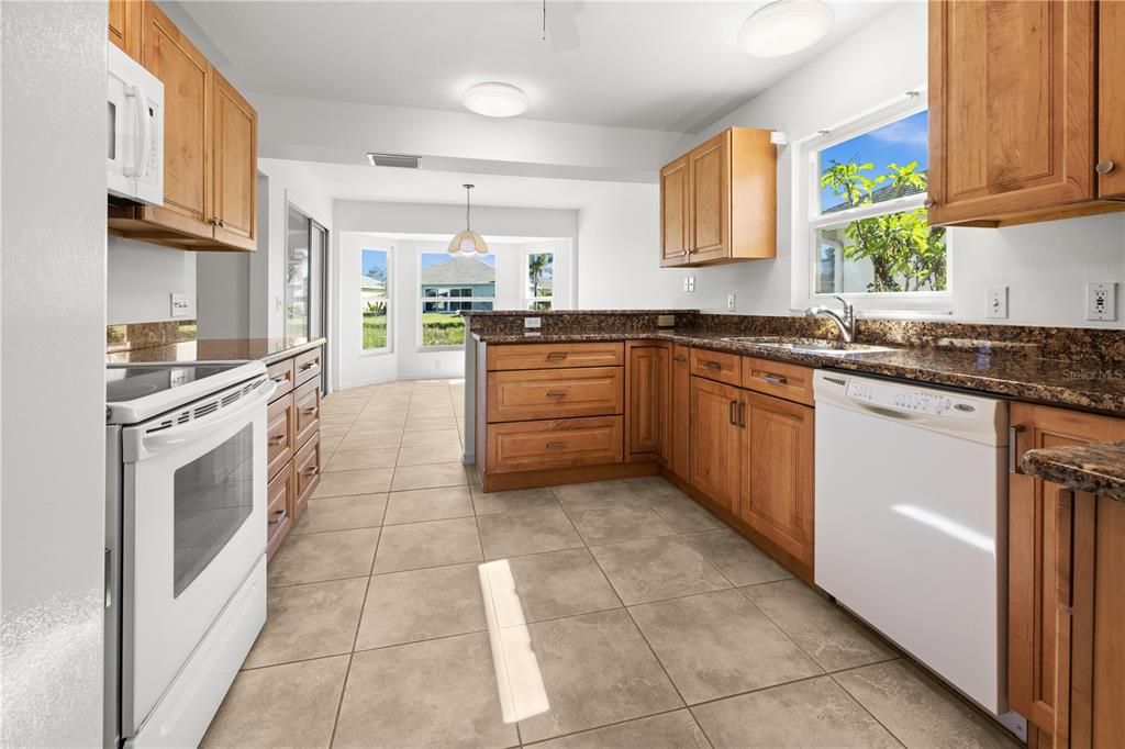 THE TASTEFUL CABINETRY IS COMPLEMENTED BY BEAUTIFUL GRANITE COUNTERTOPS