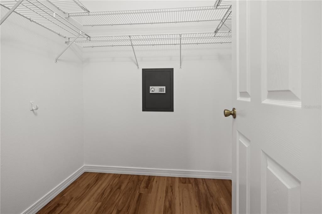 THE PRIMARY BEDROOM WALK-IN CLOSET HAS A SAFE