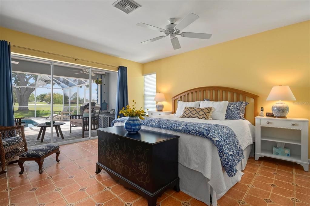 Primary bedroom with slider to lanai, pool